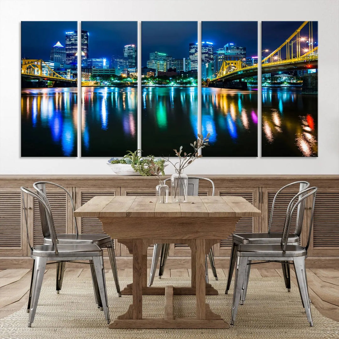 The "Downtown Pittsburgh at Night Canvas Wall Art" is a stunning museum-quality print that showcases the Pittsburgh skyline, reflecting over water and adorned with bright city lights.