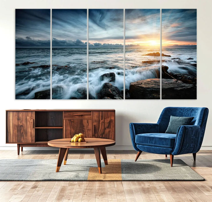 Dynamic Ocean Waves Triptych Canvas Art, a stunning giclee canvas print showcasing a dramatic ocean sunrise with waves crashing on rocks, hangs prominently to create a captivating coastal ambiance.