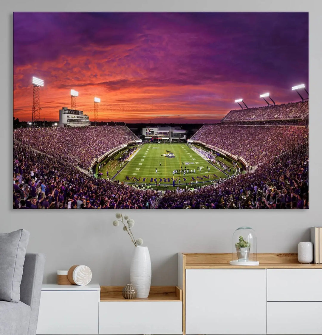 The East Carolina University Pirates Football Team Print, showcasing the vibrant Greenville Dowdy-Ficklen Stadium at sunset on museum-quality canvas and handcrafted in the USA, is a stunning piece of wall art.