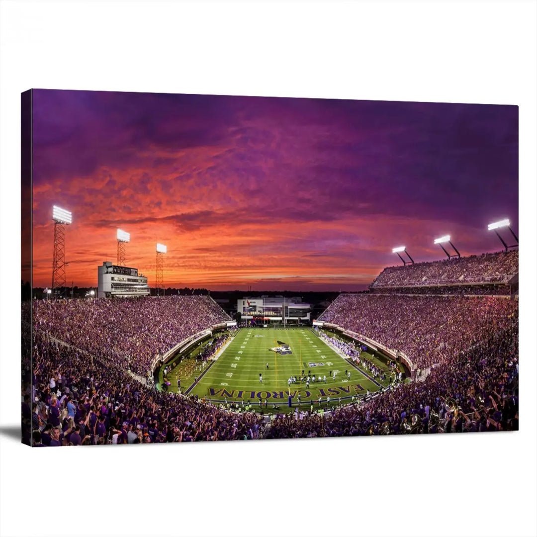 The East Carolina University Pirates Football Team Print, showcasing the vibrant Greenville Dowdy-Ficklen Stadium at sunset on museum-quality canvas and handcrafted in the USA, is a stunning piece of wall art.