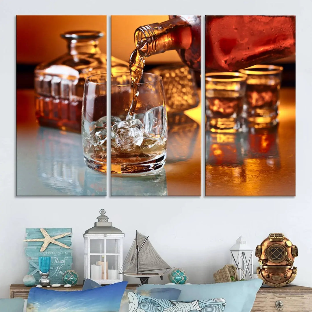 The Elegant Whiskey Canvas Art captures the reflection of a whiskey bottle pouring into an iced glass beside two filled ones.