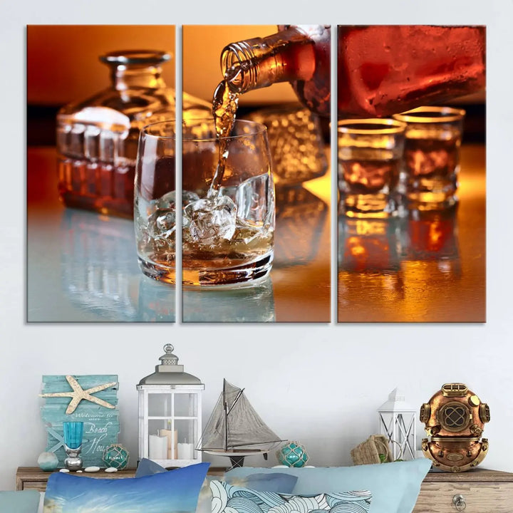 The Elegant Whiskey Canvas Art captures the reflection of a whiskey bottle pouring into an iced glass beside two filled ones.