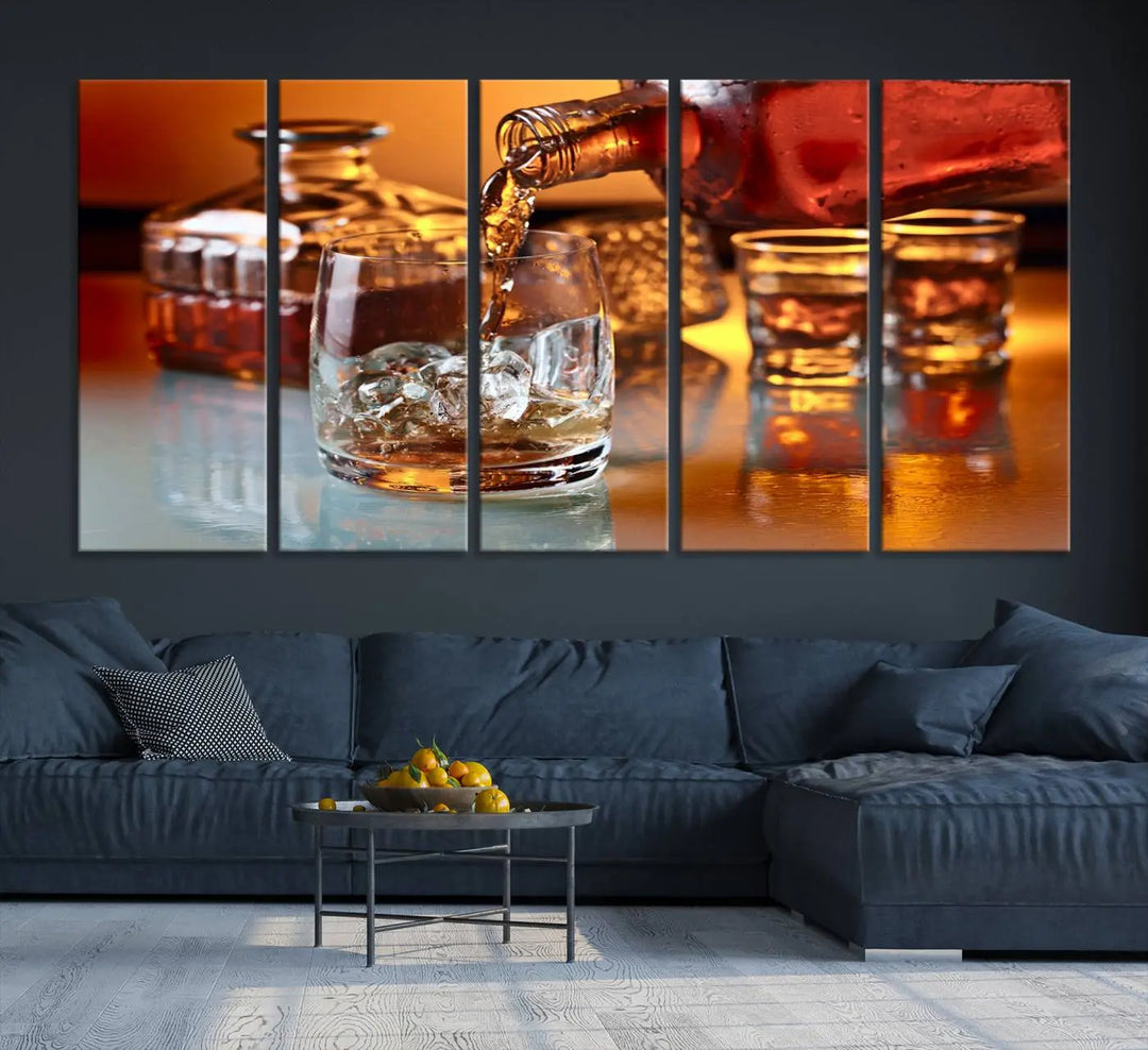 The Elegant Whiskey Canvas Art captures the reflection of a whiskey bottle pouring into an iced glass beside two filled ones.