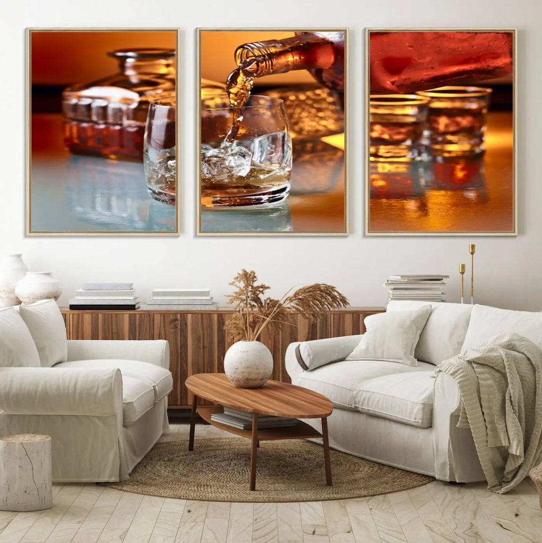 The Elegant Whiskey Canvas Art captures the reflection of a whiskey bottle pouring into an iced glass beside two filled ones.