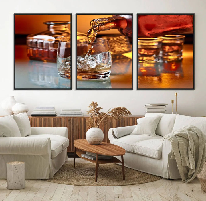 The Elegant Whiskey Canvas Art captures the reflection of a whiskey bottle pouring into an iced glass beside two filled ones.