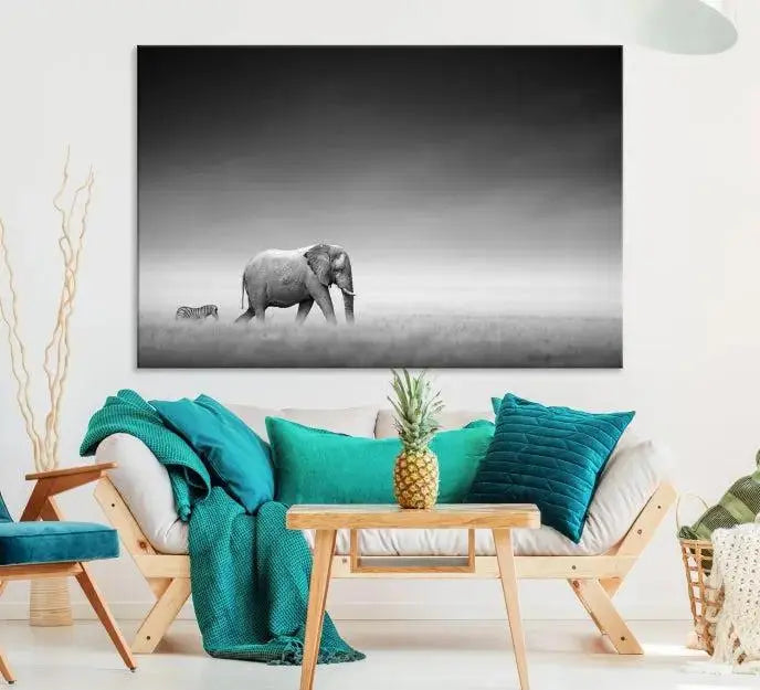 Elephant and Zebra Wall Art Canvas Print: A black and white triptych on museum-quality canvas, showcasing an elephant and zebra walking across a grassy plain. Equipped with a UV-protective coating for lasting protection.