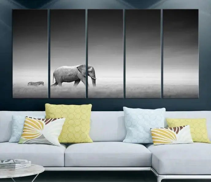 Elephant and Zebra Wall Art Canvas Print: A black and white triptych on museum-quality canvas, showcasing an elephant and zebra walking across a grassy plain. Equipped with a UV-protective coating for lasting protection.