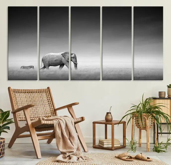 Elephant and Zebra Wall Art Canvas Print: A black and white triptych on museum-quality canvas, showcasing an elephant and zebra walking across a grassy plain. Equipped with a UV-protective coating for lasting protection.