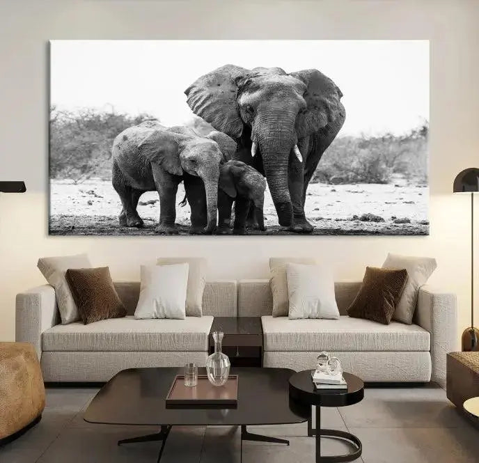 The Elephant Family Africa Wall Art Canvas Print, a black and white triptych of elephants, is presented as museum-quality canvas art.