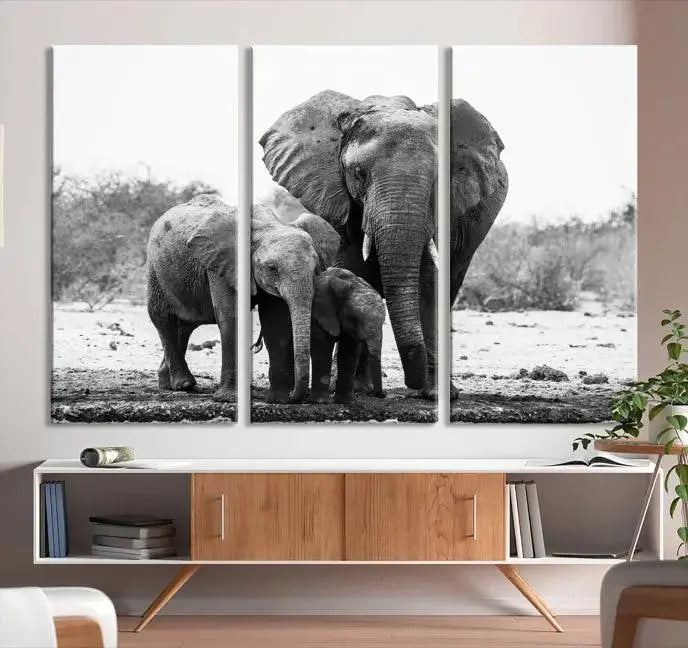 The Elephant Family Africa Wall Art Canvas Print, a black and white triptych of elephants, is presented as museum-quality canvas art.