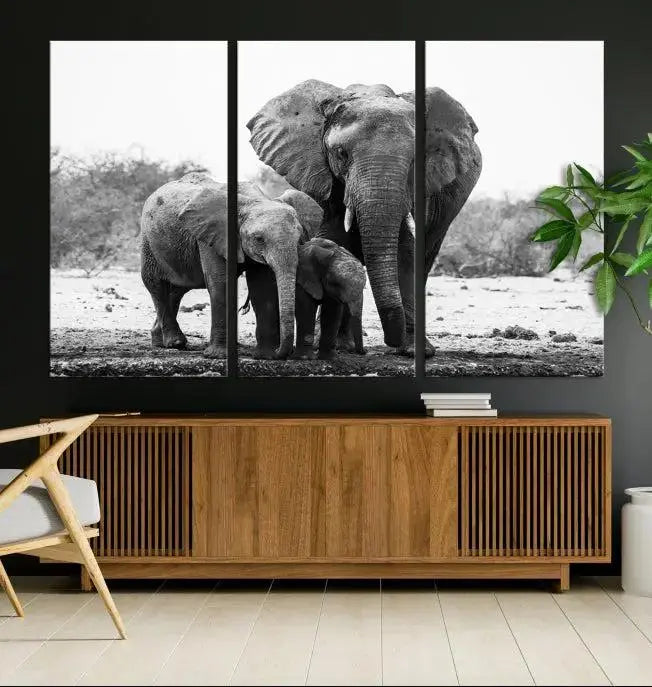 The Elephant Family Africa Wall Art Canvas Print, a black and white triptych of elephants, is presented as museum-quality canvas art.