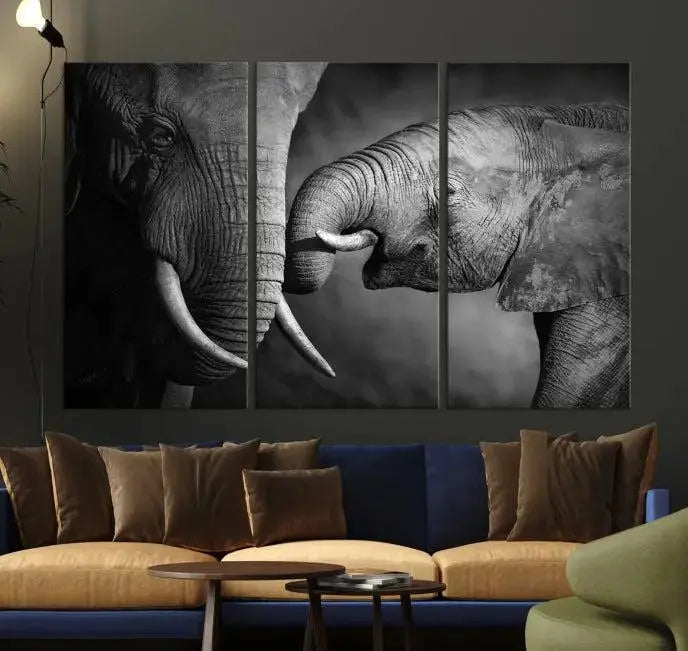 The "Elephant Family Wall Art Canvas Print" is a black-and-white triptych depicting elephants touching trunks, crafted on museum-quality canvas with a UV-protective coating. This ready-to-hang piece adds an elegant touch to any room.