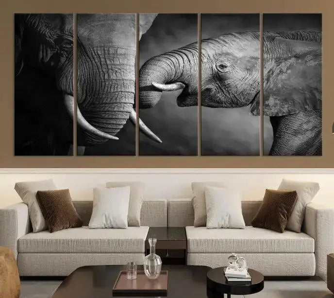 The "Elephant Family Wall Art Canvas Print" is a black-and-white triptych depicting elephants touching trunks, crafted on museum-quality canvas with a UV-protective coating. This ready-to-hang piece adds an elegant touch to any room.