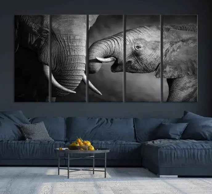 The "Elephant Family Wall Art Canvas Print" is a black-and-white triptych depicting elephants touching trunks, crafted on museum-quality canvas with a UV-protective coating. This ready-to-hang piece adds an elegant touch to any room.