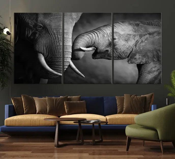 The "Elephant Family Wall Art Canvas Print" is a black-and-white triptych depicting elephants touching trunks, crafted on museum-quality canvas with a UV-protective coating. This ready-to-hang piece adds an elegant touch to any room.