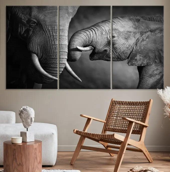 The "Elephant Family Wall Art Canvas Print" is a black-and-white triptych depicting elephants touching trunks, crafted on museum-quality canvas with a UV-protective coating. This ready-to-hang piece adds an elegant touch to any room.