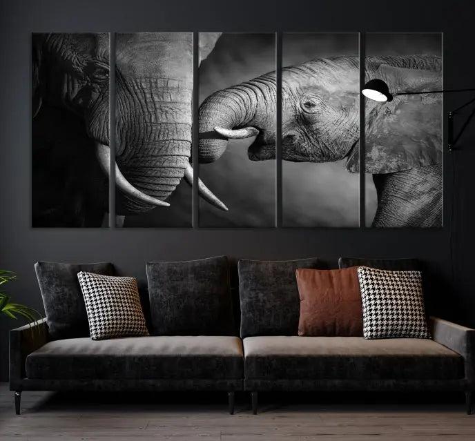 The "Elephant Family Wall Art Canvas Print" is a black-and-white triptych depicting elephants touching trunks, crafted on museum-quality canvas with a UV-protective coating. This ready-to-hang piece adds an elegant touch to any room.