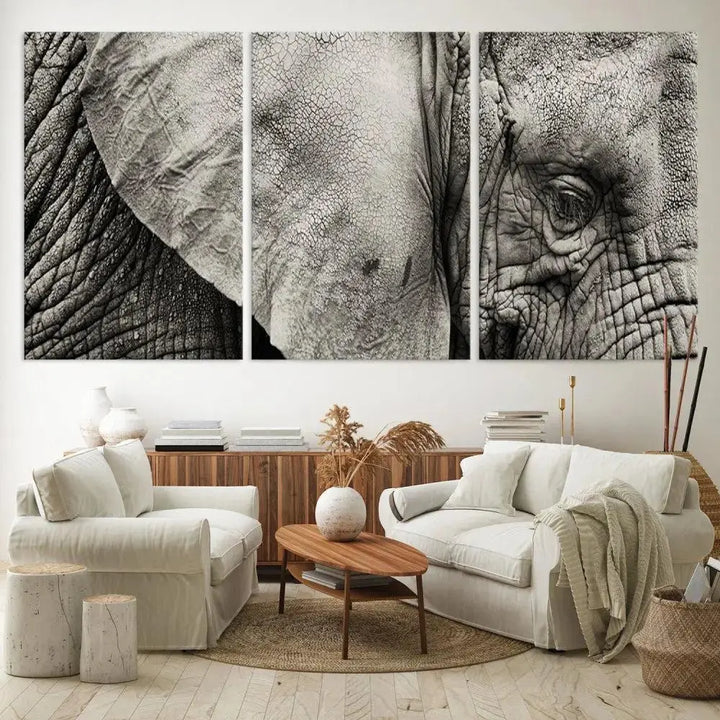 A modern living room features a large Elephant Wall Art Canvas Print in black and white, crafted on museum-quality canvases with UV-protective coating to maintain its elegance.