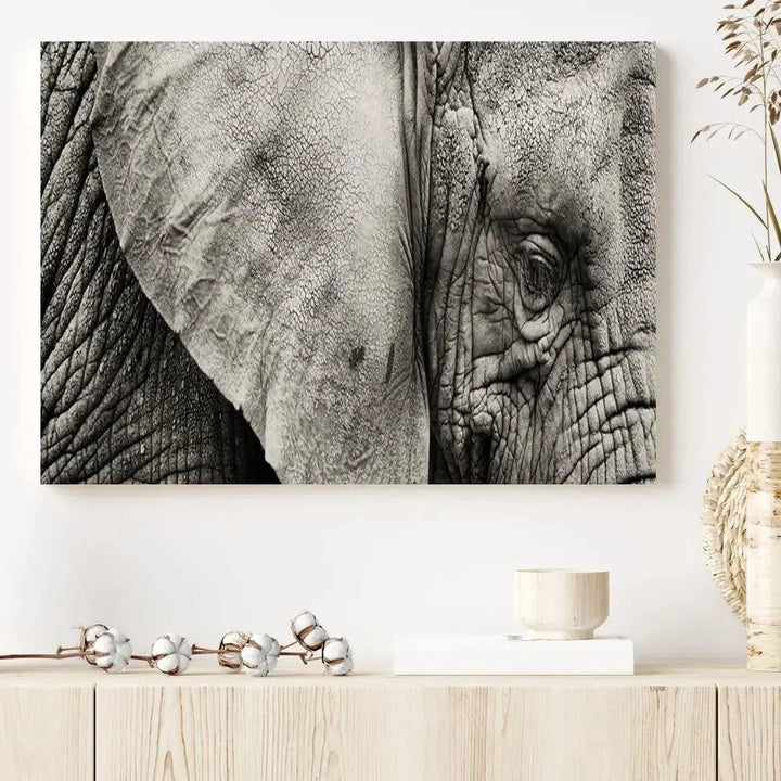 A modern living room features a large Elephant Wall Art Canvas Print in black and white, crafted on museum-quality canvases with UV-protective coating to maintain its elegance.