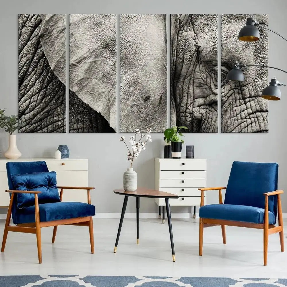 A modern living room features a large Elephant Wall Art Canvas Print in black and white, crafted on museum-quality canvases with UV-protective coating to maintain its elegance.