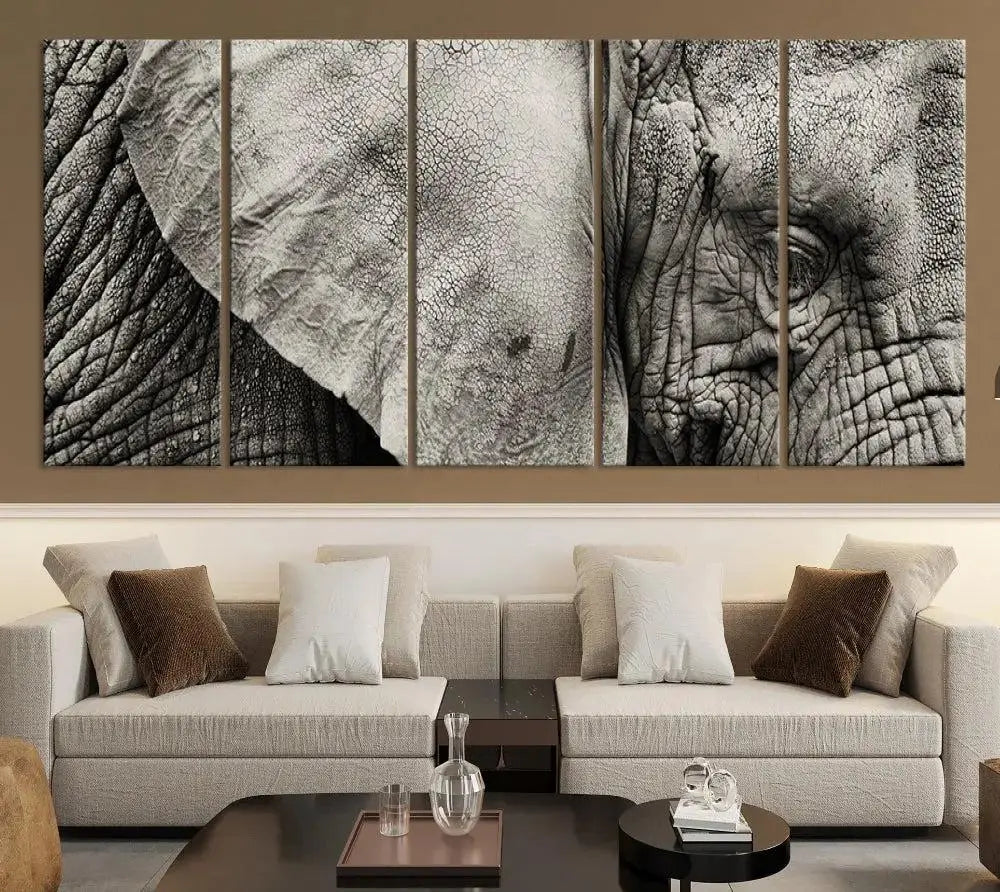 A modern living room features a large Elephant Wall Art Canvas Print in black and white, crafted on museum-quality canvases with UV-protective coating to maintain its elegance.