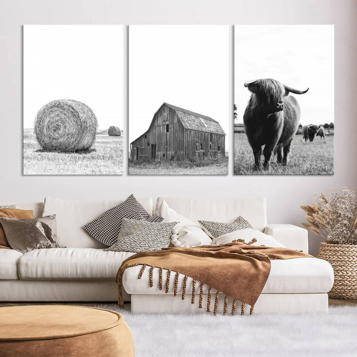 The Farmhouse Wall Art Decor Canvas Print, a triptych artwork, showcases a hay bale, wooden barn, and Highland cow in a meadow. Crafted on museum-quality canvas with neutral tones to create a cozy ambiance, this piece is handcrafted in the USA to enhance any space.