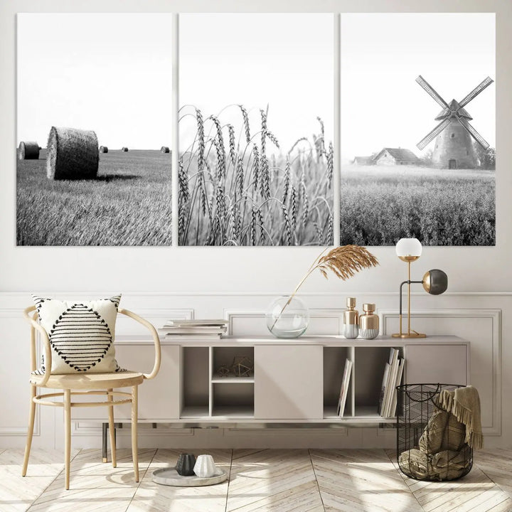 The "Farmhouse Windmill and Wheat Field Black and White 3-Panel Wall Art" brings rustic charm with its depiction of hay bales, wheat, and a windmill. This ready-to-hang canvas print creates an inviting country-inspired atmosphere in any space.