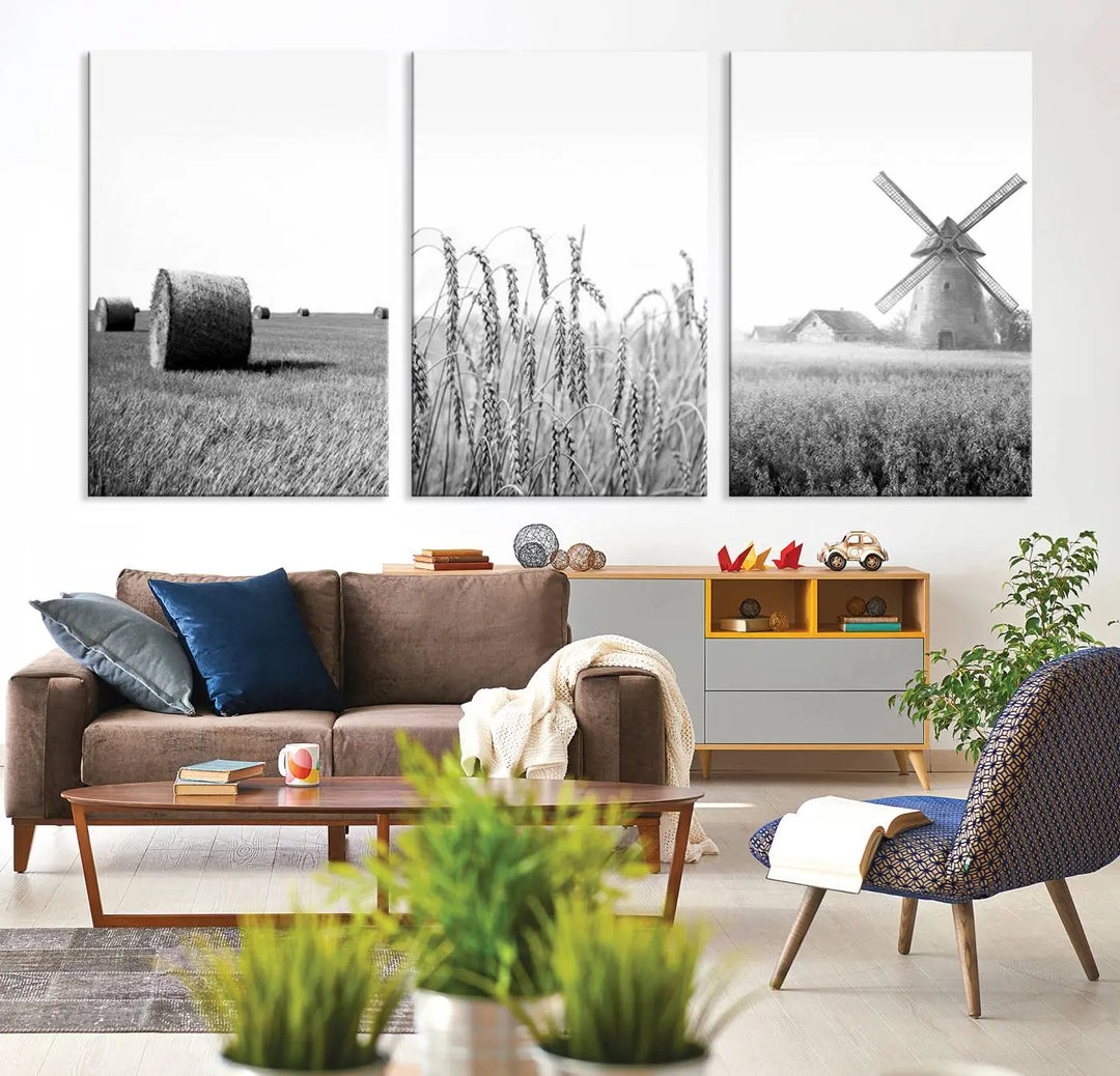 The "Farmhouse Windmill and Wheat Field Black and White 3-Panel Wall Art" brings rustic charm with its depiction of hay bales, wheat, and a windmill. This ready-to-hang canvas print creates an inviting country-inspired atmosphere in any space.