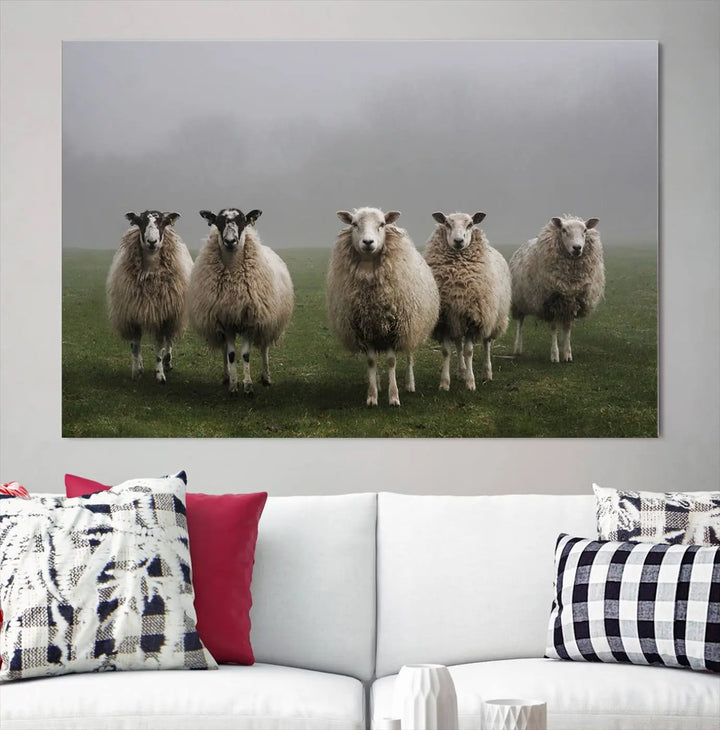 The "Flock of Sheep in a Mystical Fog" pastoral wall art canvas print, framed and ready to hang, adds a touch of farmhouse decor to the room.