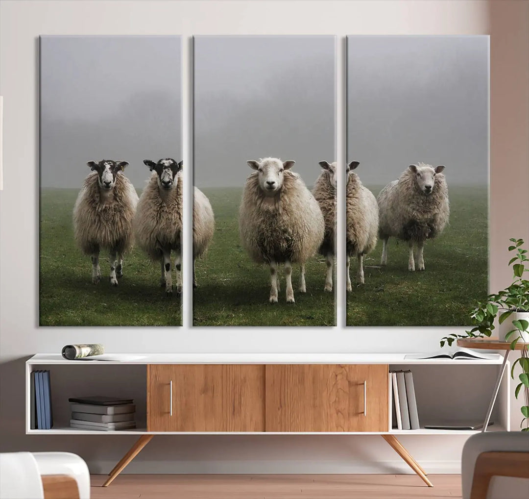 The "Flock of Sheep in a Mystical Fog" pastoral wall art canvas print, framed and ready to hang, adds a touch of farmhouse decor to the room.