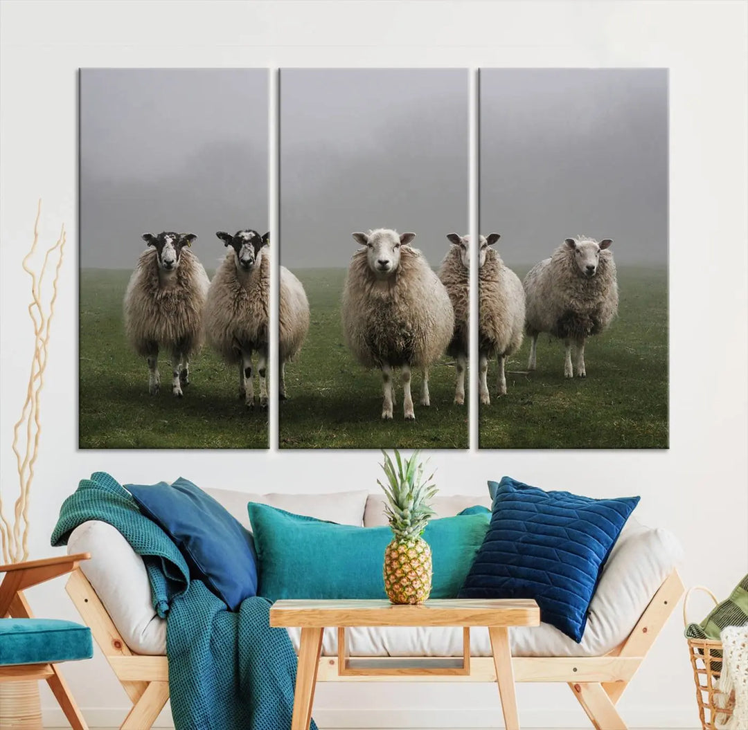 The "Flock of Sheep in a Mystical Fog" pastoral wall art canvas print, framed and ready to hang, adds a touch of farmhouse decor to the room.