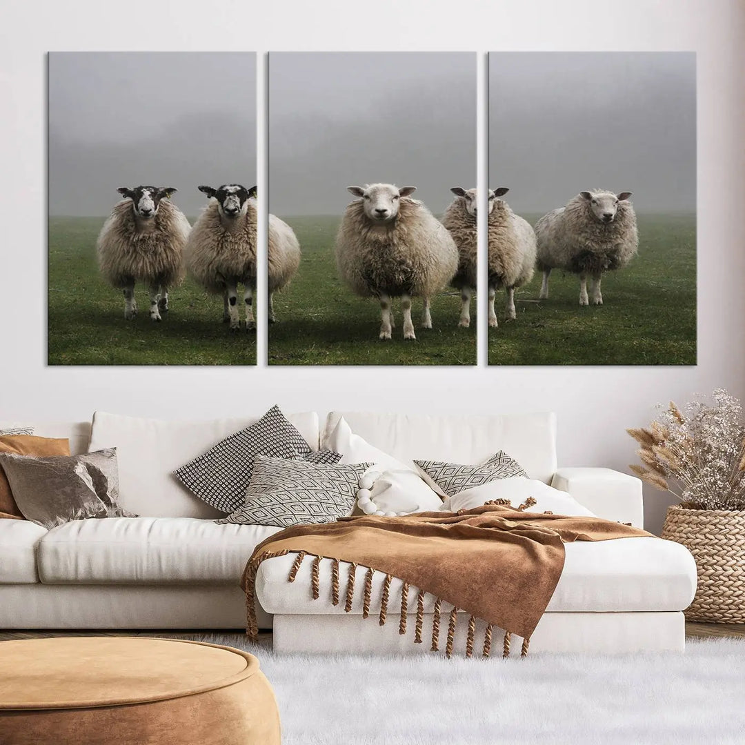 The "Flock of Sheep in a Mystical Fog" pastoral wall art canvas print, framed and ready to hang, adds a touch of farmhouse decor to the room.