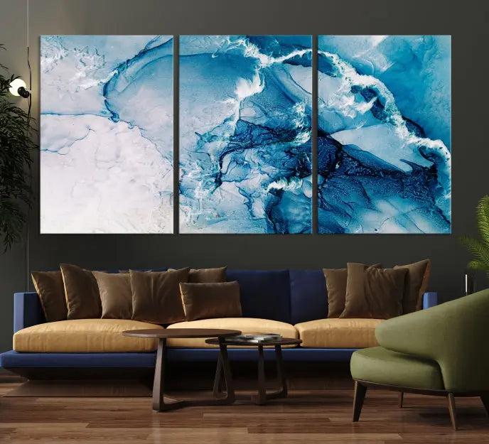 A set of Fluid Effect Wall Art Abstract Canvas prints, showcasing blue and white abstract designs on museum-quality canvas, is tastefully arranged on a dark wall.