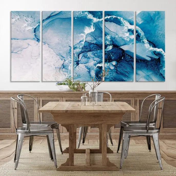 A set of Fluid Effect Wall Art Abstract Canvas prints, showcasing blue and white abstract designs on museum-quality canvas, is tastefully arranged on a dark wall.