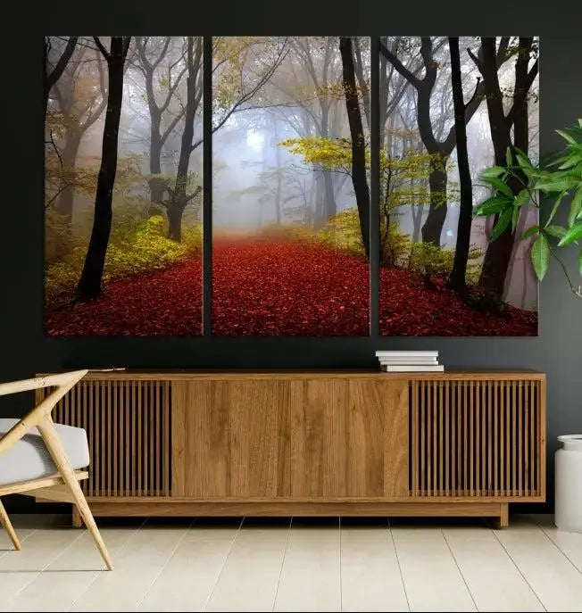 The Foggy Forest Wall Art Landscape Canvas Print beautifully enhances the space. This triptych artwork showcases a misty autumn forest with a red-leafed path, presented on museum-quality canvases with UV-protective coating for enduring allure. Enjoy the added benefit of free shipping on your purchase.