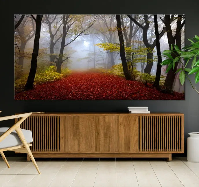 The Foggy Forest Wall Art Landscape Canvas Print beautifully enhances the space. This triptych artwork showcases a misty autumn forest with a red-leafed path, presented on museum-quality canvases with UV-protective coating for enduring allure. Enjoy the added benefit of free shipping on your purchase.