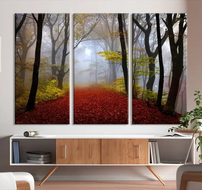 The Foggy Forest Wall Art Landscape Canvas Print beautifully enhances the space. This triptych artwork showcases a misty autumn forest with a red-leafed path, presented on museum-quality canvases with UV-protective coating for enduring allure. Enjoy the added benefit of free shipping on your purchase.