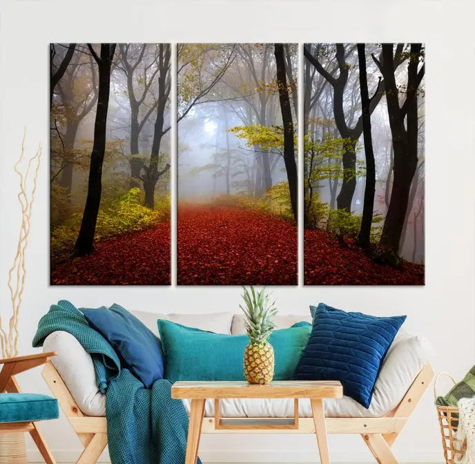 The Foggy Forest Wall Art Landscape Canvas Print beautifully enhances the space. This triptych artwork showcases a misty autumn forest with a red-leafed path, presented on museum-quality canvases with UV-protective coating for enduring allure. Enjoy the added benefit of free shipping on your purchase.