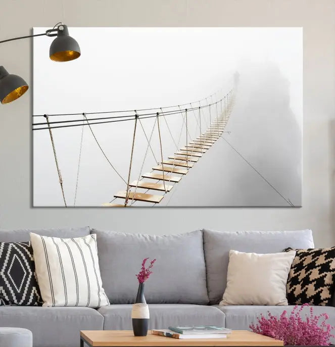 The Foggy and Wood Bridge Wall Art Canvas Print, with its UV-protective coating, elegantly adorns the living room wall. This museum-quality canvas depicting a foggy skywalk bridge exudes a captivating allure that remains timeless.