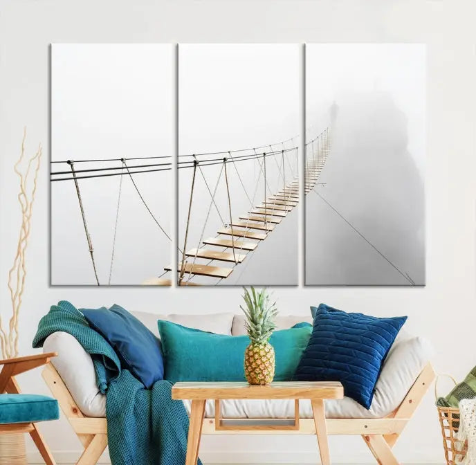 The Foggy and Wood Bridge Wall Art Canvas Print, with its UV-protective coating, elegantly adorns the living room wall. This museum-quality canvas depicting a foggy skywalk bridge exudes a captivating allure that remains timeless.