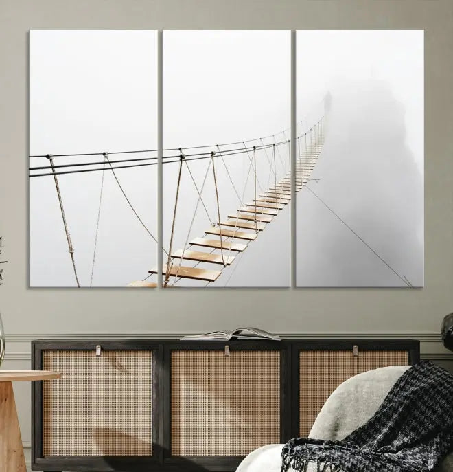 The Foggy and Wood Bridge Wall Art Canvas Print, with its UV-protective coating, elegantly adorns the living room wall. This museum-quality canvas depicting a foggy skywalk bridge exudes a captivating allure that remains timeless.