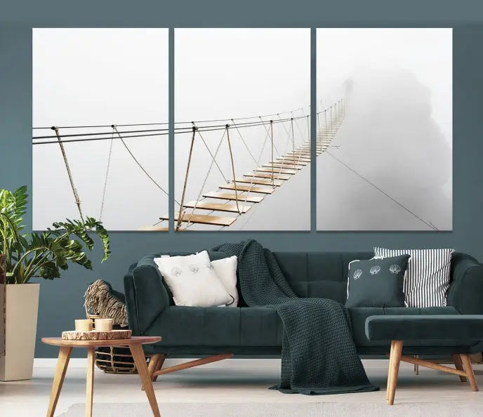 The Foggy and Wood Bridge Wall Art Canvas Print, with its UV-protective coating, elegantly adorns the living room wall. This museum-quality canvas depicting a foggy skywalk bridge exudes a captivating allure that remains timeless.