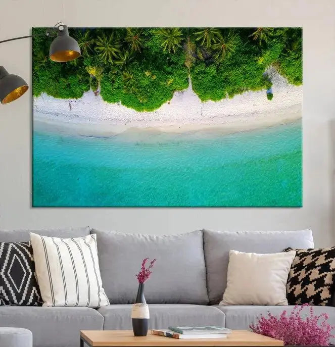 The Forest and Aerial Ocean Wall Art Canvas Print depicts a tropical beach scene, showcasing turquoise waters, white sand, and lush green trees. This triptych is gallery wrapped on museum-quality canvas and features a UV-protective coating to maintain its vibrant colors.