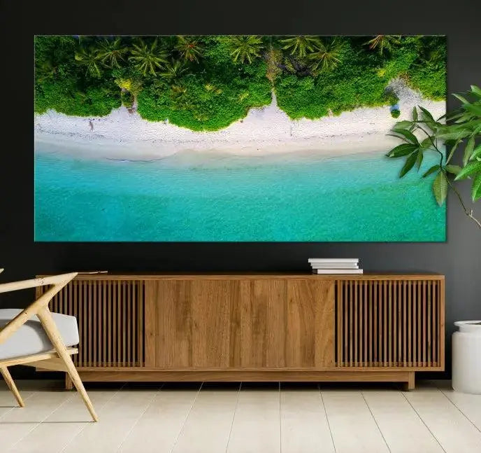 The Forest and Aerial Ocean Wall Art Canvas Print depicts a tropical beach scene, showcasing turquoise waters, white sand, and lush green trees. This triptych is gallery wrapped on museum-quality canvas and features a UV-protective coating to maintain its vibrant colors.