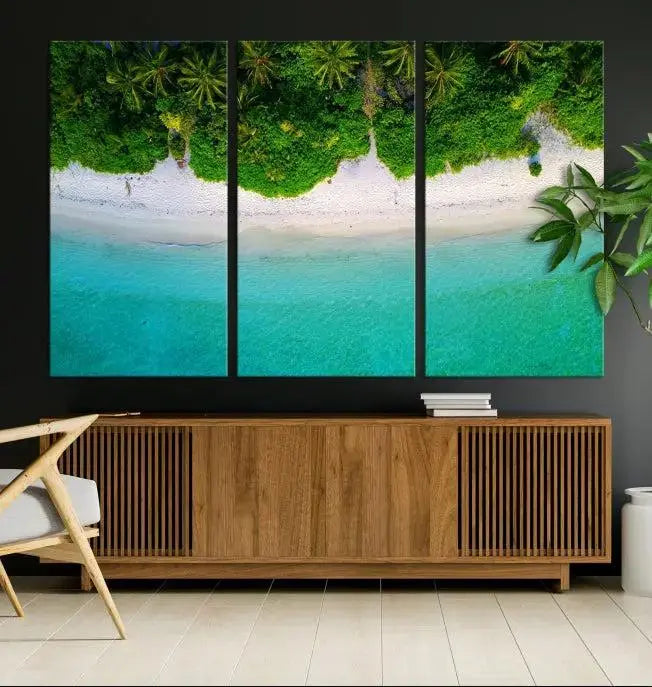 The Forest and Aerial Ocean Wall Art Canvas Print depicts a tropical beach scene, showcasing turquoise waters, white sand, and lush green trees. This triptych is gallery wrapped on museum-quality canvas and features a UV-protective coating to maintain its vibrant colors.