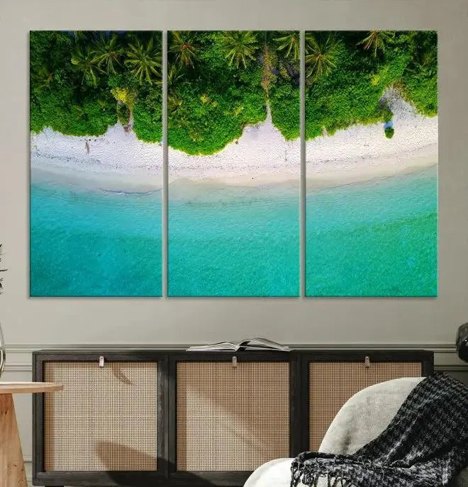 The Forest and Aerial Ocean Wall Art Canvas Print depicts a tropical beach scene, showcasing turquoise waters, white sand, and lush green trees. This triptych is gallery wrapped on museum-quality canvas and features a UV-protective coating to maintain its vibrant colors.