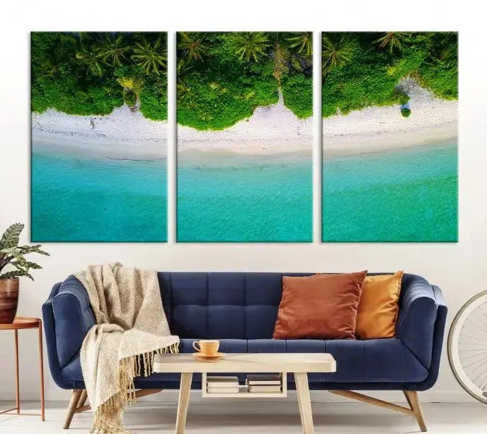 The Forest and Aerial Ocean Wall Art Canvas Print depicts a tropical beach scene, showcasing turquoise waters, white sand, and lush green trees. This triptych is gallery wrapped on museum-quality canvas and features a UV-protective coating to maintain its vibrant colors.