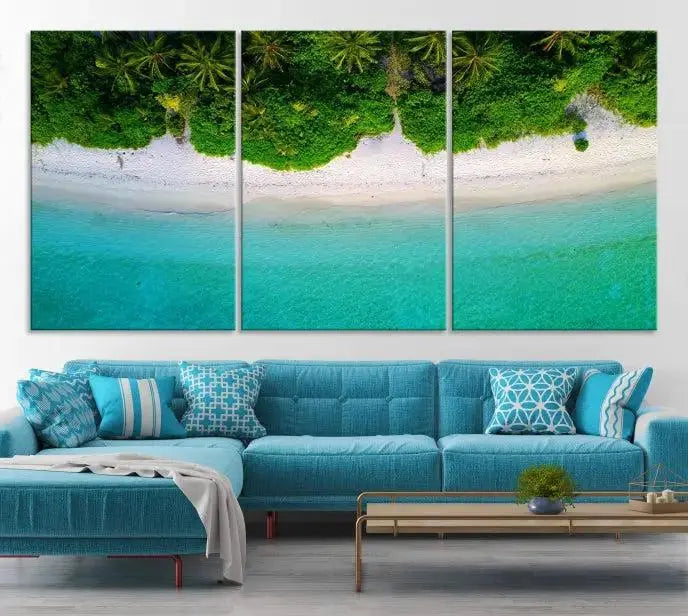 The Forest and Aerial Ocean Wall Art Canvas Print depicts a tropical beach scene, showcasing turquoise waters, white sand, and lush green trees. This triptych is gallery wrapped on museum-quality canvas and features a UV-protective coating to maintain its vibrant colors.