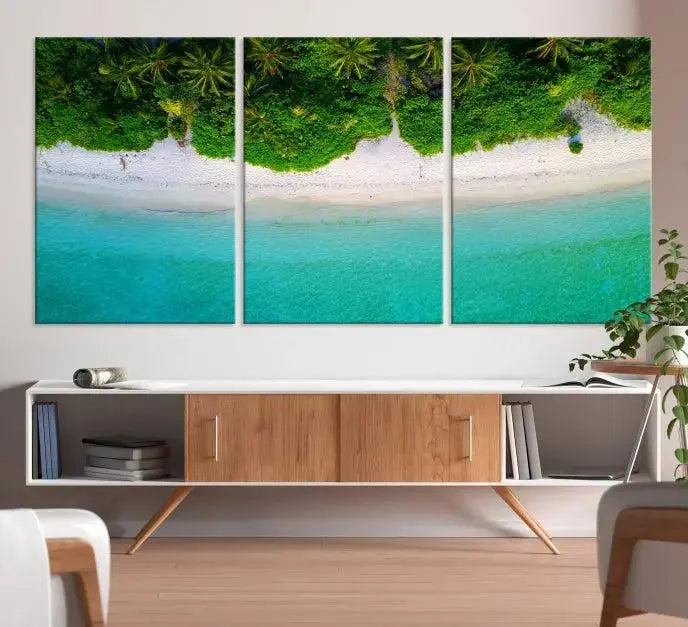 The Forest and Aerial Ocean Wall Art Canvas Print depicts a tropical beach scene, showcasing turquoise waters, white sand, and lush green trees. This triptych is gallery wrapped on museum-quality canvas and features a UV-protective coating to maintain its vibrant colors.