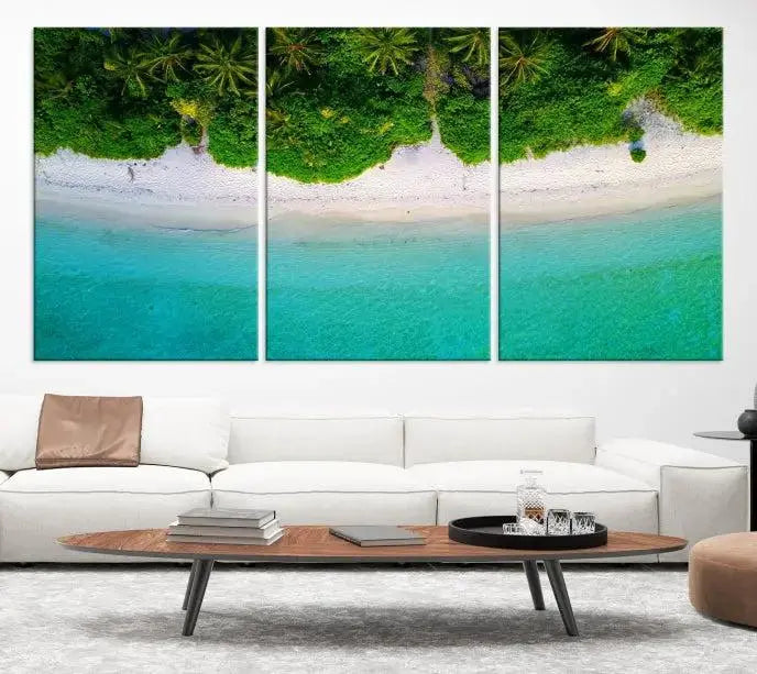 The Forest and Aerial Ocean Wall Art Canvas Print depicts a tropical beach scene, showcasing turquoise waters, white sand, and lush green trees. This triptych is gallery wrapped on museum-quality canvas and features a UV-protective coating to maintain its vibrant colors.